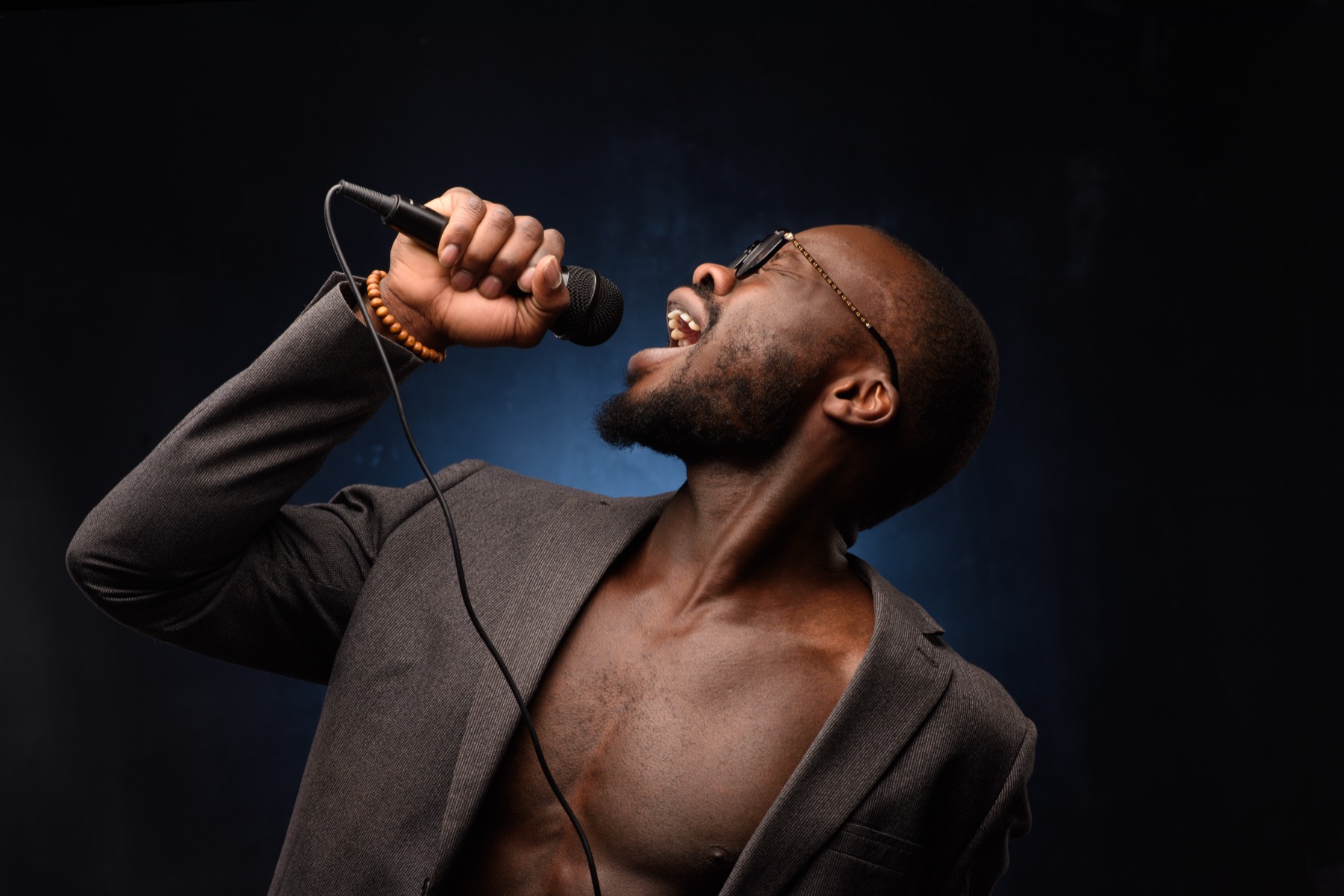 A vocalist performing under stage lights